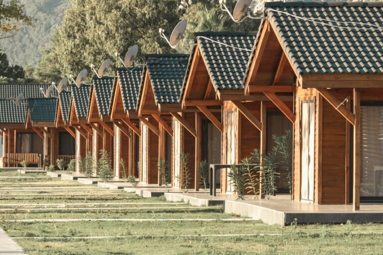 Cozy wooden cabins in a serene resort ideal for a summer getaway and relaxation.